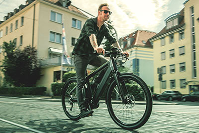 A man riding a Winora bicycle can be seen riding through the city center.